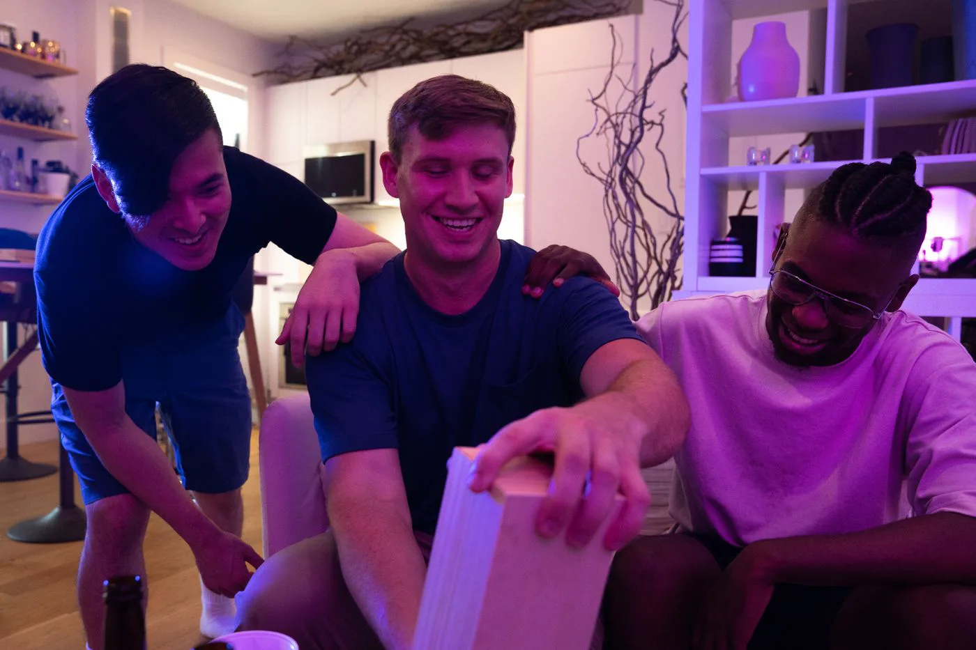 Teens laughing together during game night