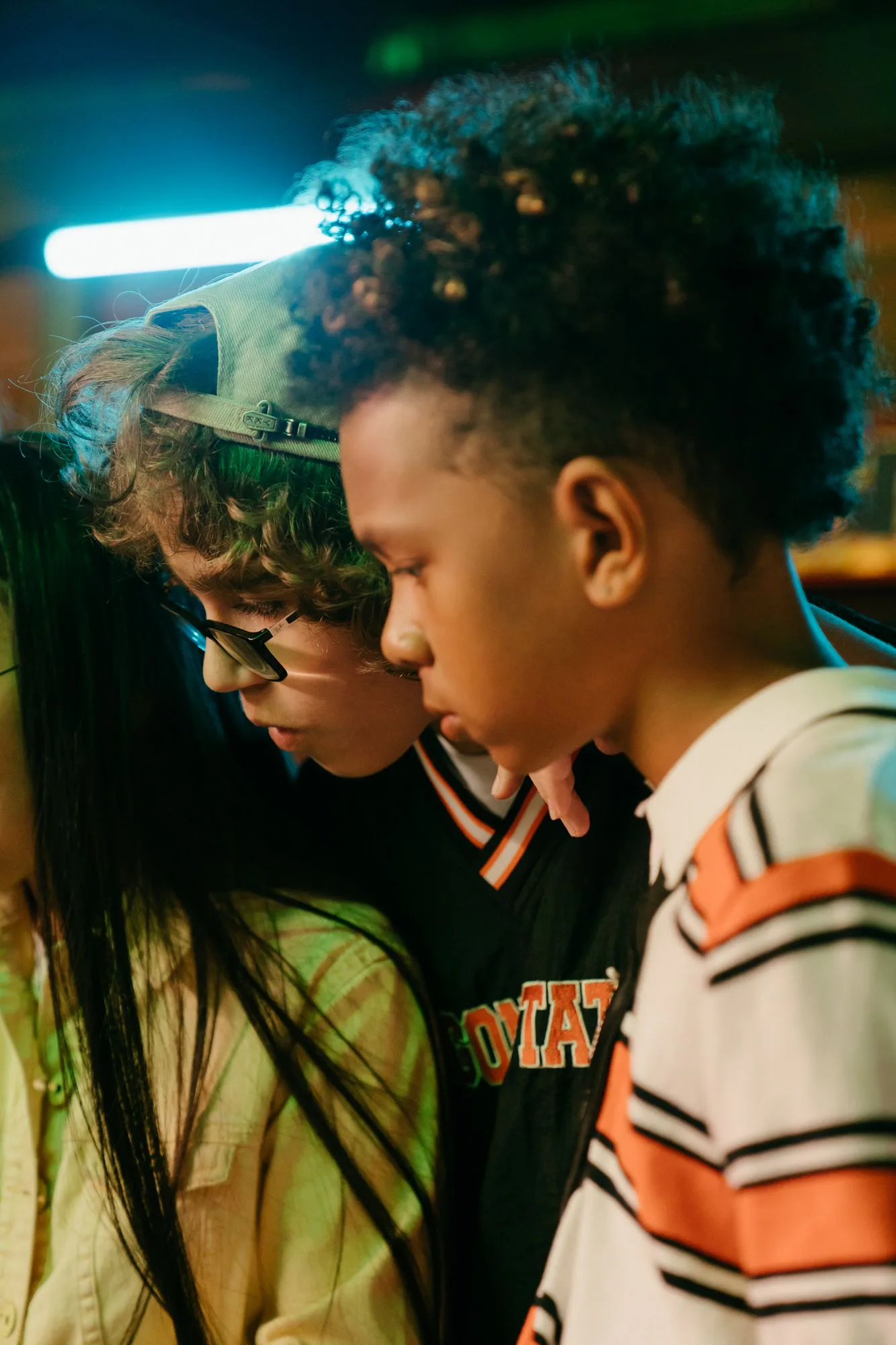 Teens talking together under neon light