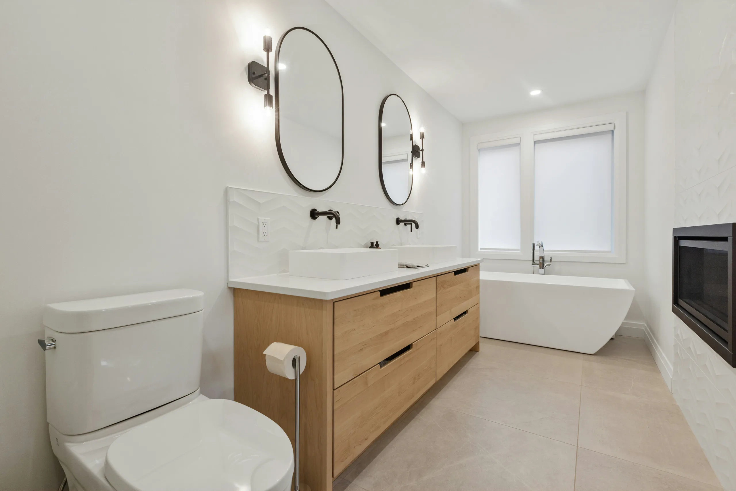 Tradesperson carefully fitting a bathroom sink and chrome tap during a renovation