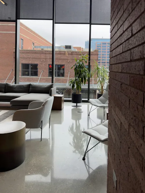 Modern commercial lounge with tiled floor and city view, office tiling Dublin