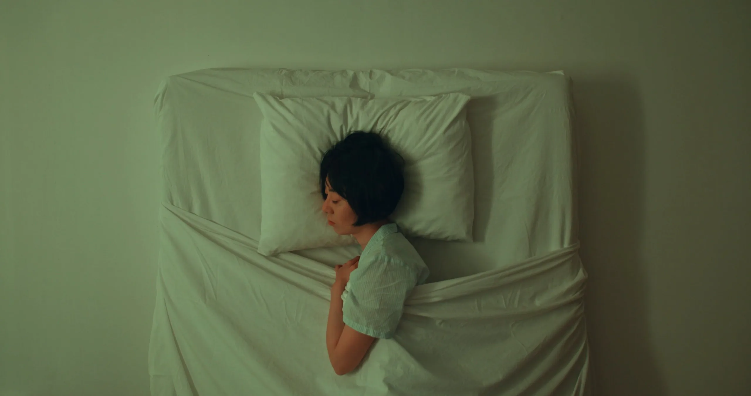 Adult sleeping in a calm bedroom