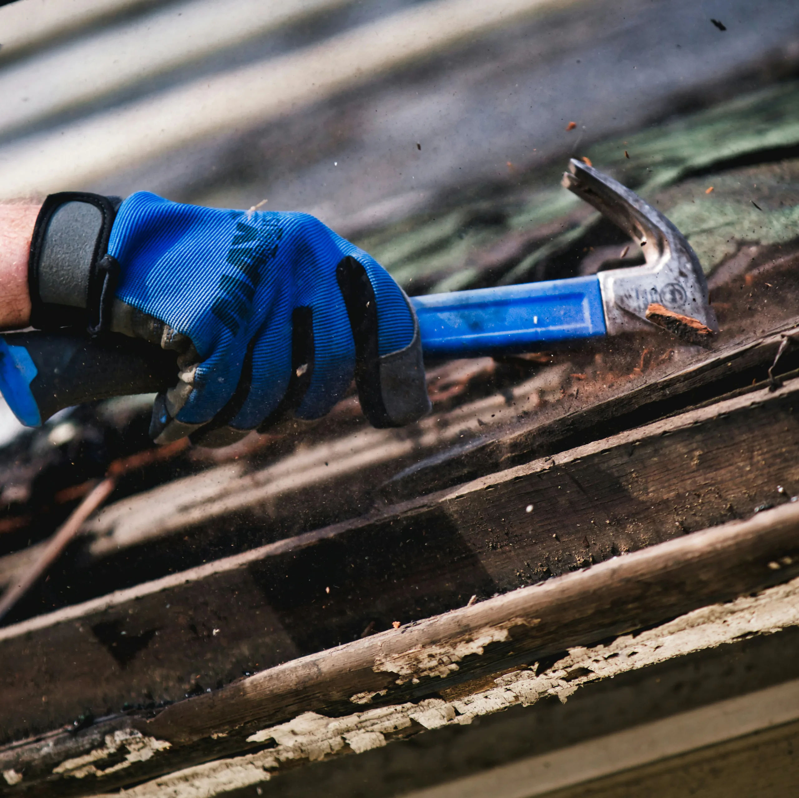 Roofer carrying out roof repair work with a hammer on a property in Galway