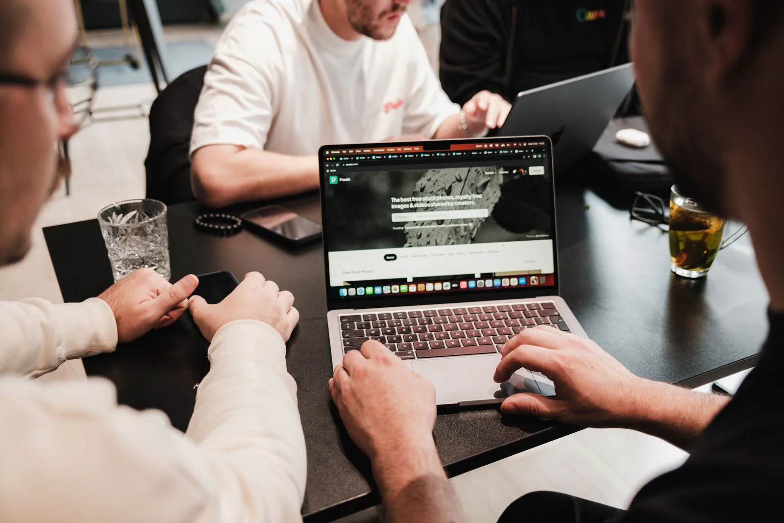 Two professionals collaborating around a laptop