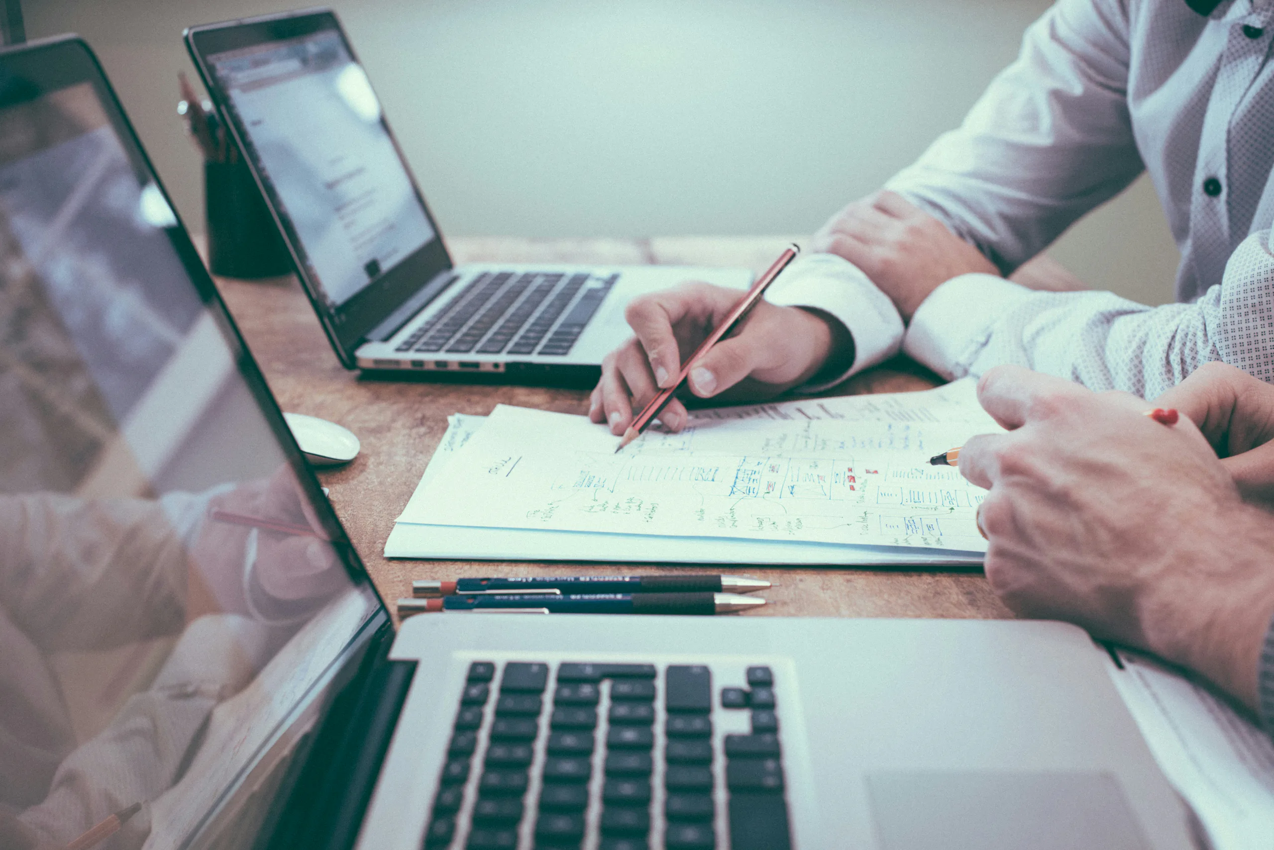 A consultant and client reviewing strategy together at a desk