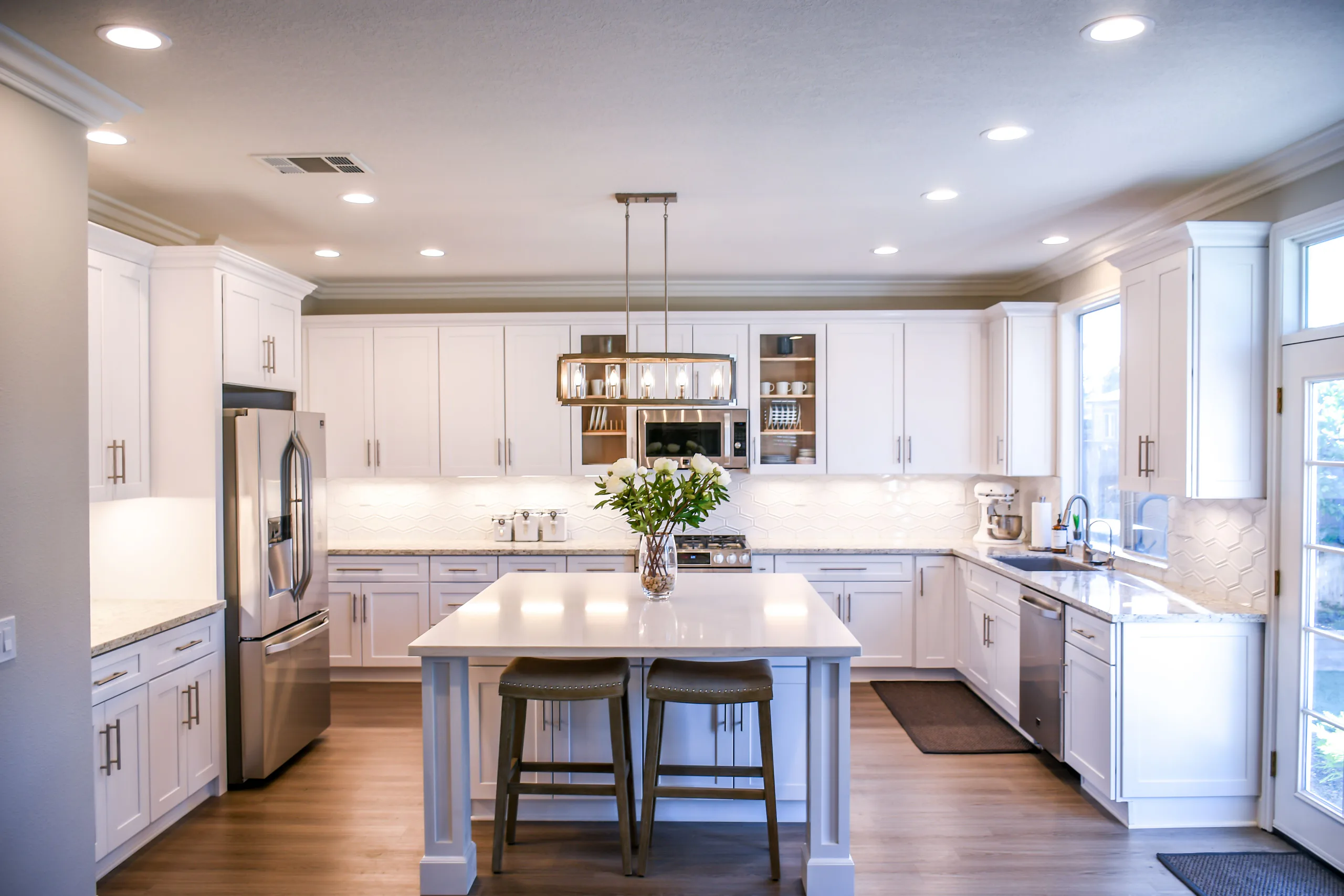 Bright modern kitchen with timber cabinetry and stone worktops installed by Select Property Services