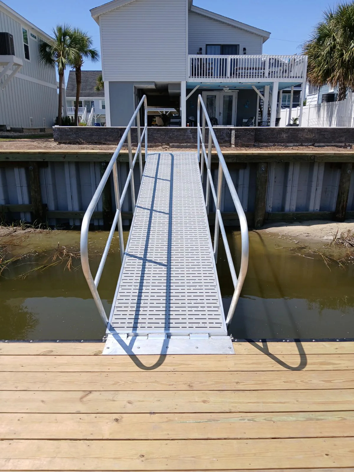 Marine construction materials including treated lumber, aluminum, and composite decking
