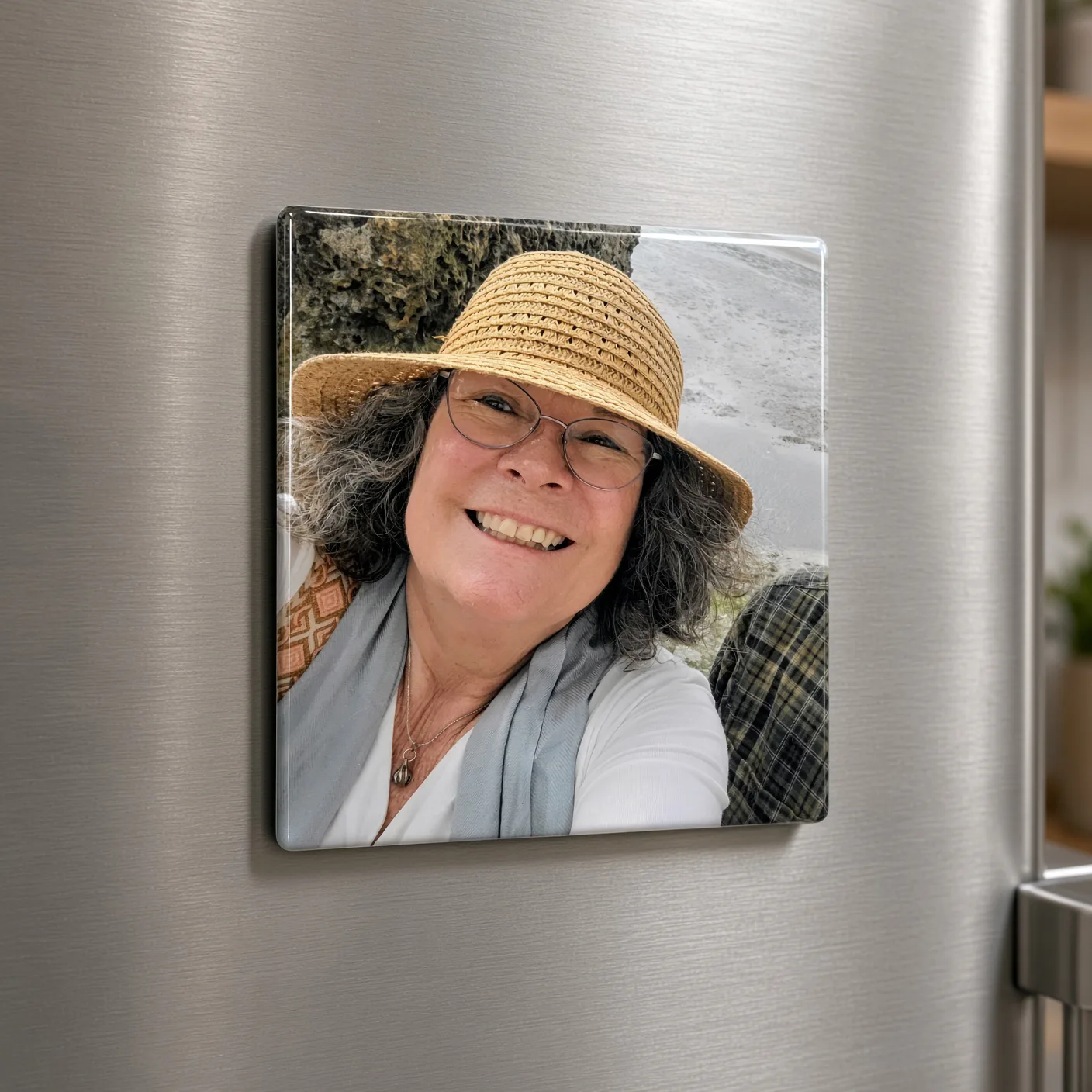 Square glossy photo magnet of a smiling woman in a straw hat on a stainless steel refrigerator