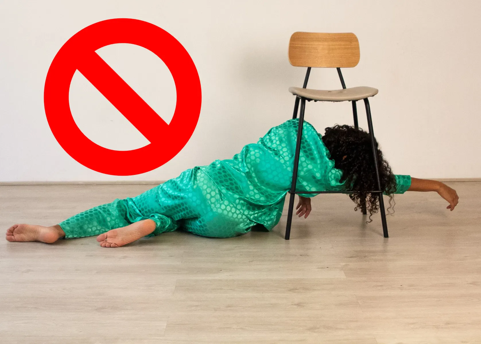 A person passed out on the floor next to a chair, illustrating poor sleep quality