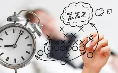 Alarm clock beside a sleeping figure, illustrating restless business thinking