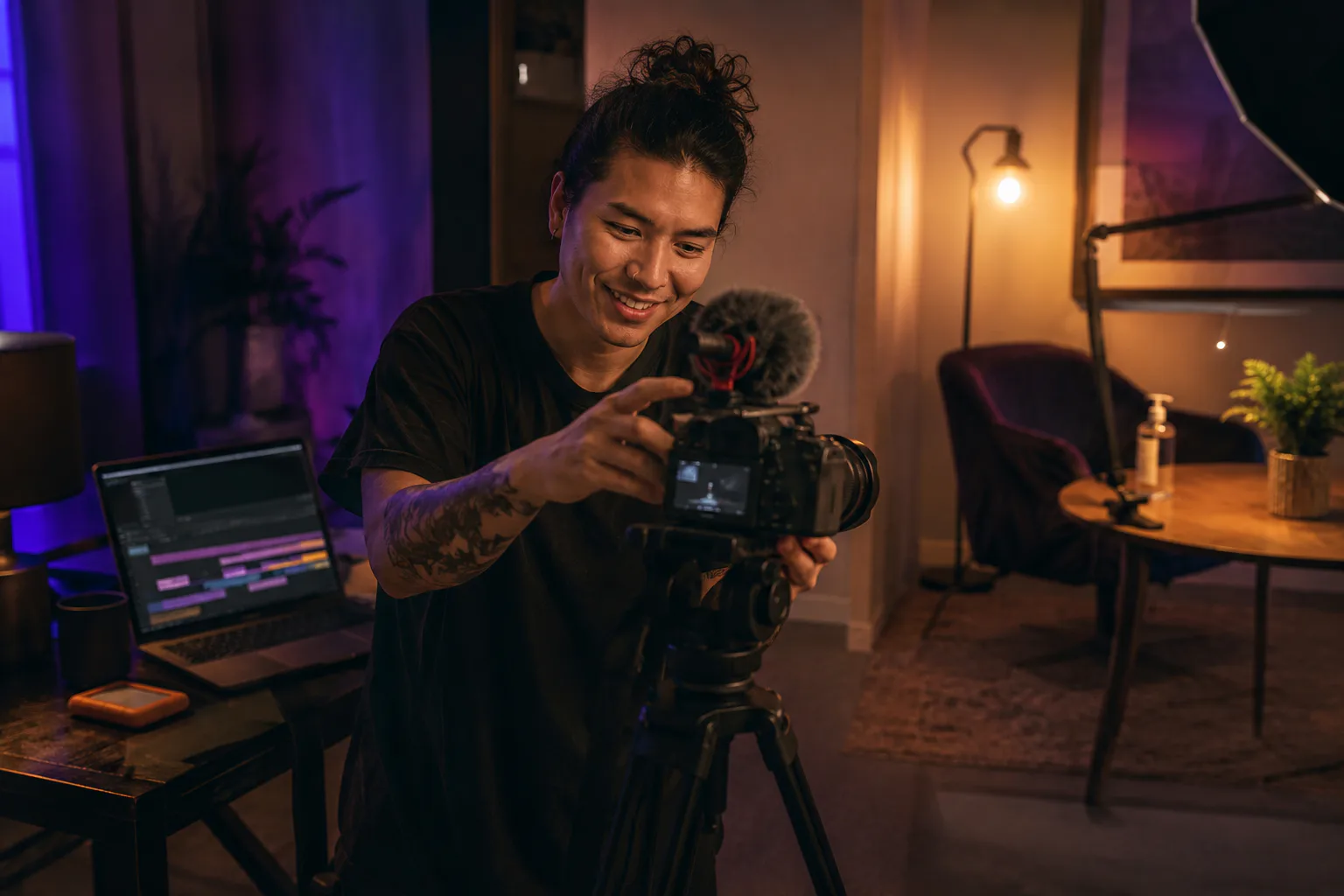 Beginner filmmaker setting up a camera beside an editing workstation