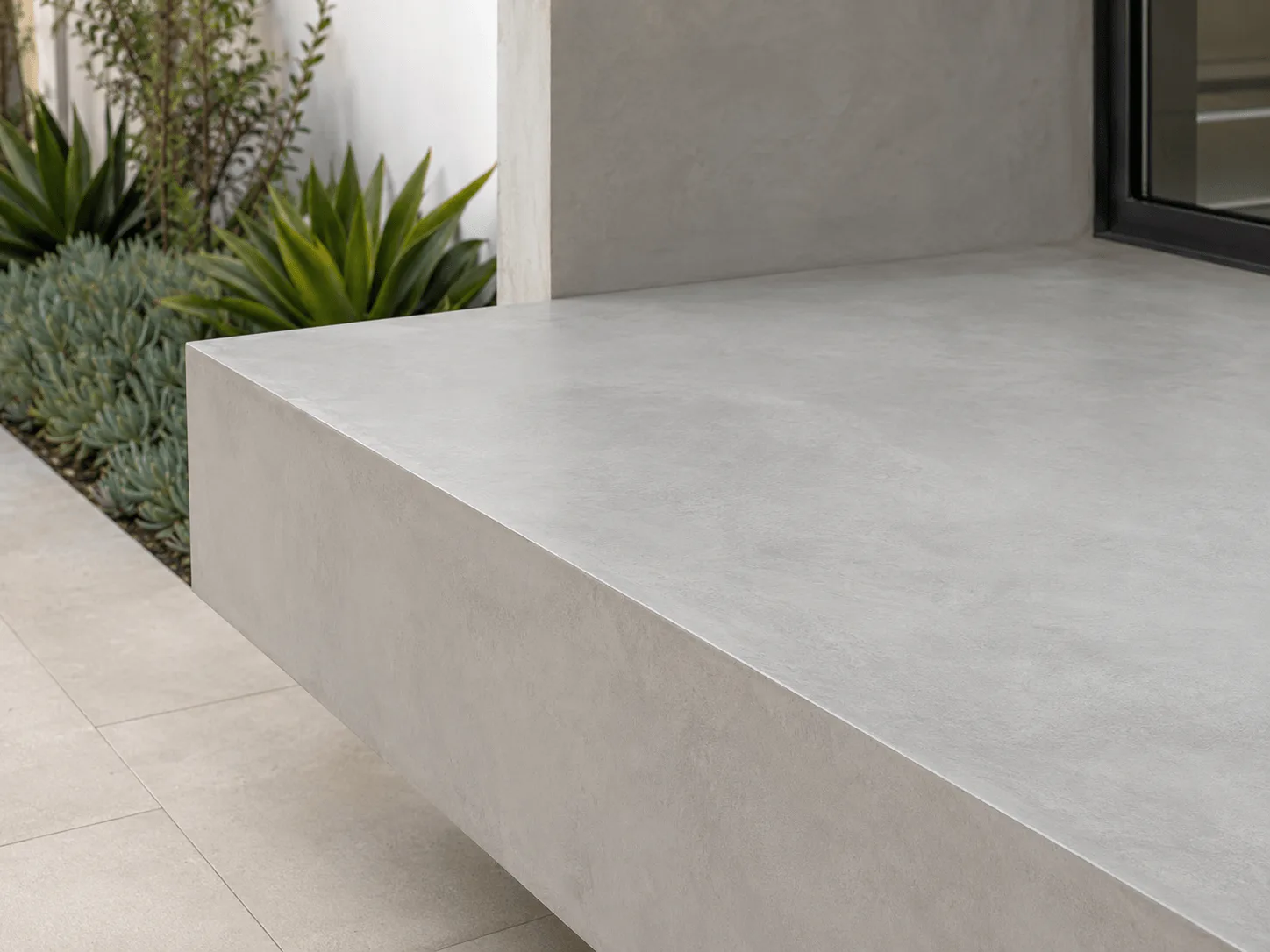 Smooth hand-troweled concrete architectural bench and surface