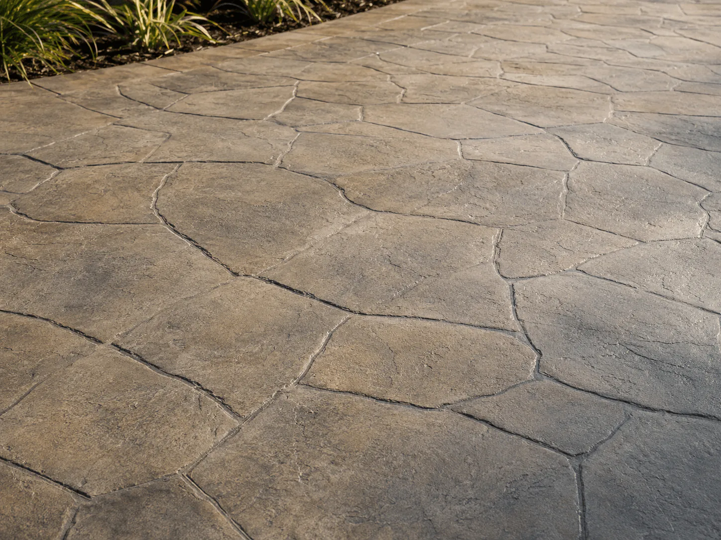 Warm taupe stamped concrete with an irregular ashlar stone pattern