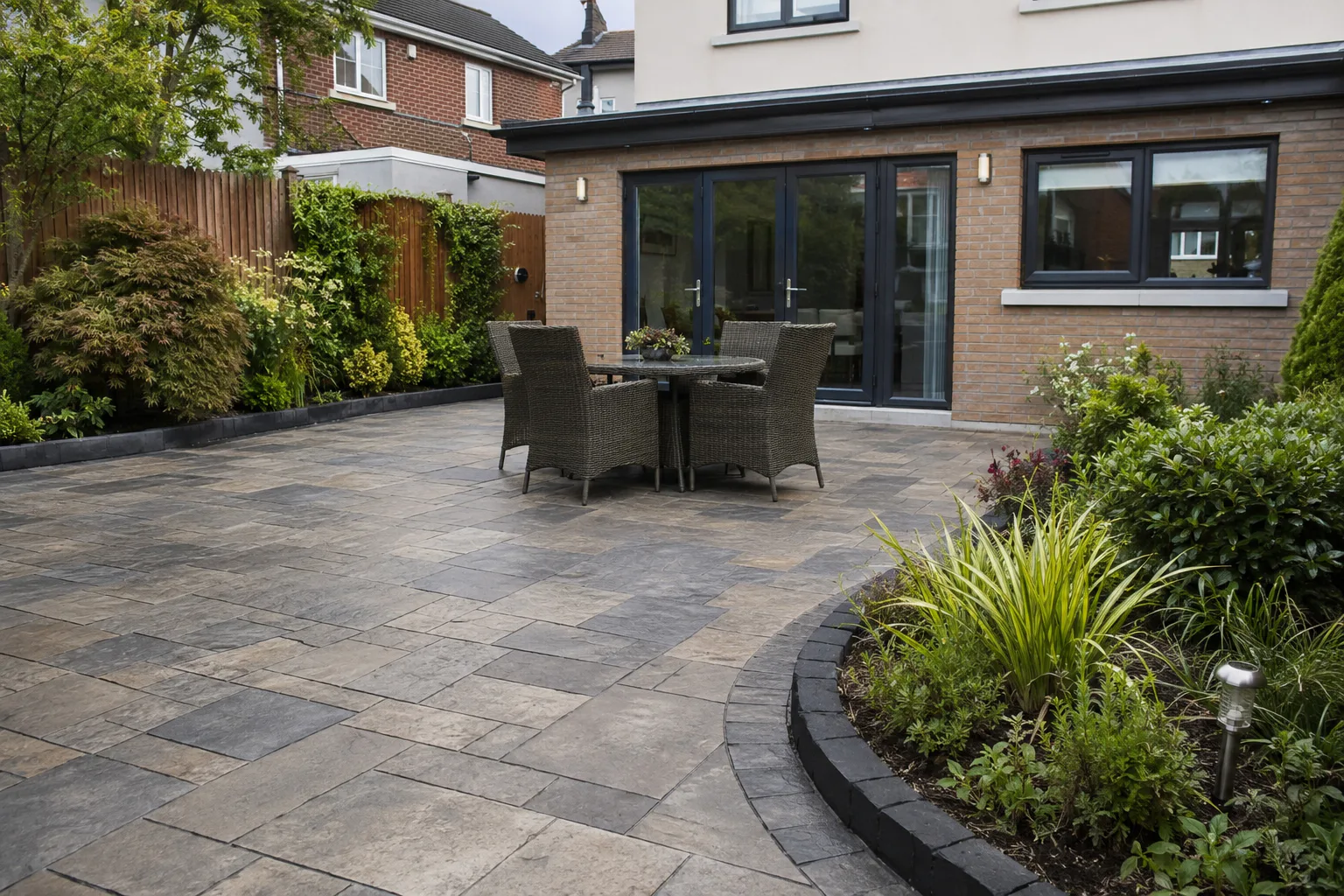 Charcoal stone-effect imprinted concrete patio in a Dublin garden