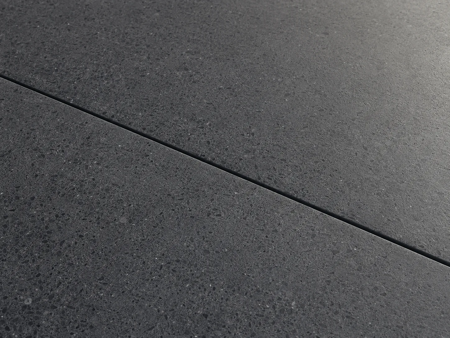 Deep charcoal sealed concrete with a subtle satin sheen