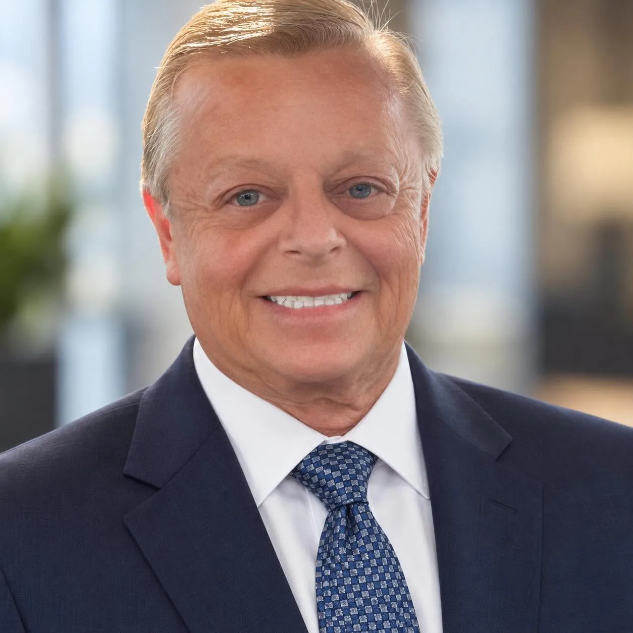 Jay Dallmann wearing a blue suit and tie