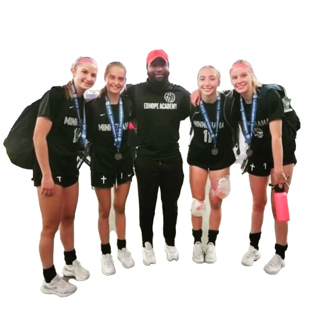 Cutout image of Coach Mulenga posing with four athletes wearing medals.