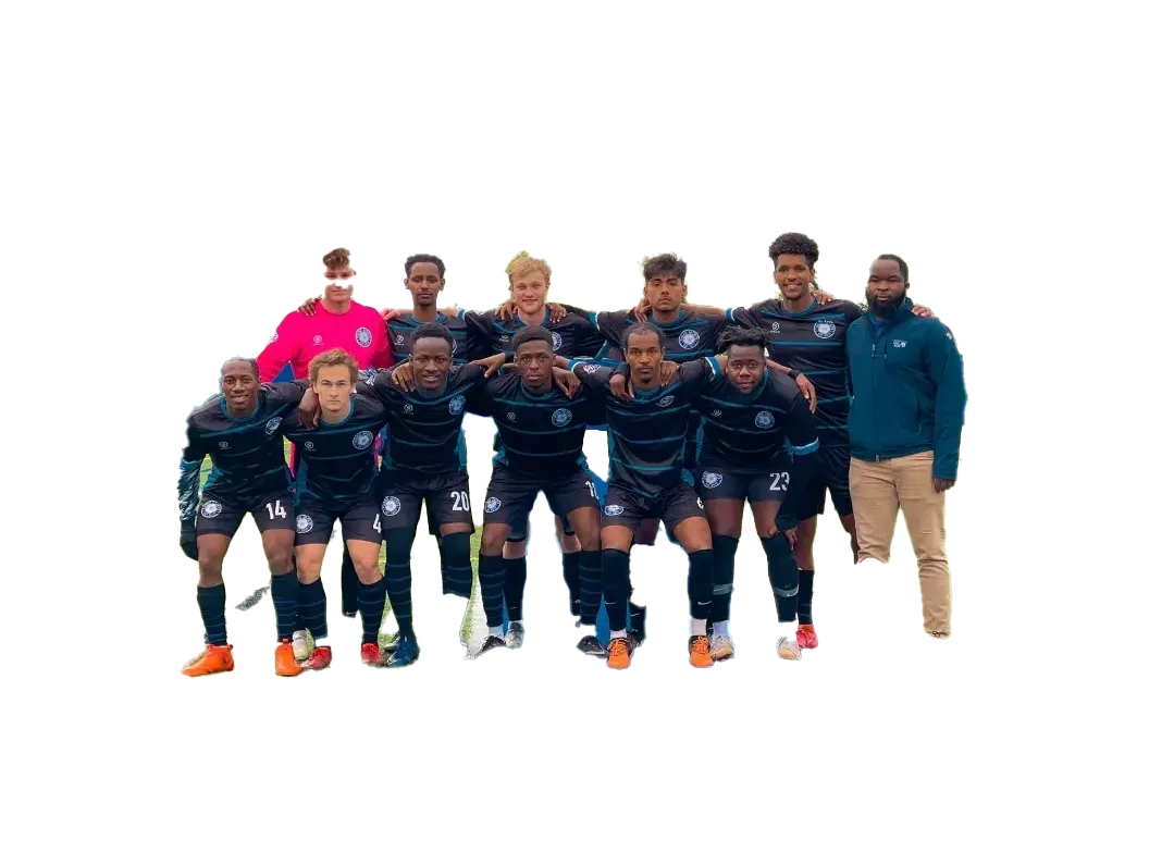 Coach Mulenga standing with an adult men's soccer team.