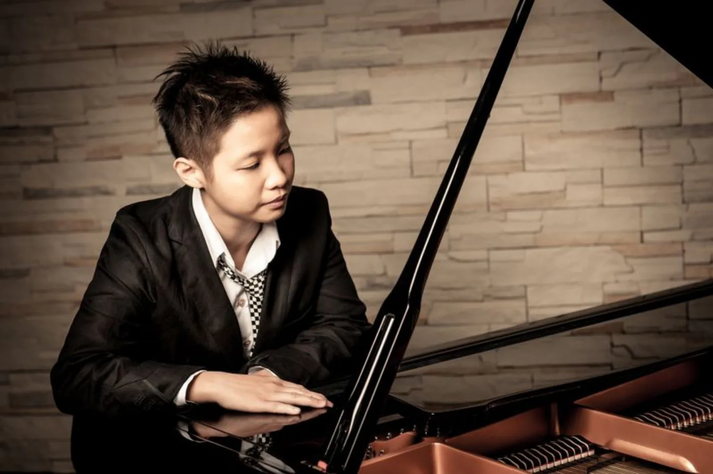 MS seated at a grand piano